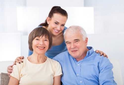 elderly couple and caregiver