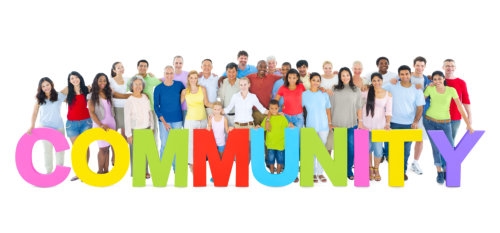 multi-ethnic group of people holding the word community